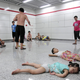 Children sleep on the floor of the Qiaosi subway station in Hangzhou, Zhejiang province July 25, 2013. More than 600 people cooled off inside the subway station as temperatures in the city hit a high of 40 degrees Centigrade during a regional power outage on Thursday. Picture taken July 25, 2013. REUTERS/Stringer